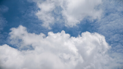 Obraz premium A serene blue sky with white clouds viewed from below on a calm day