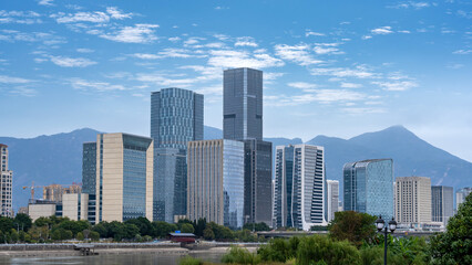 Modern City Skyline with Skyscrapers and Mountains
