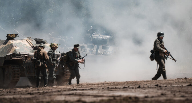 Military battle reenactment, Sherman M4 tank, infantry and armored vehicles in dust and smoke during the Bahna 2025 ground forces parade, June 21 in the Czech Republic.