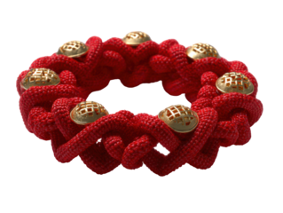 Intricate red knot bracelet with decorative gold accents on black background