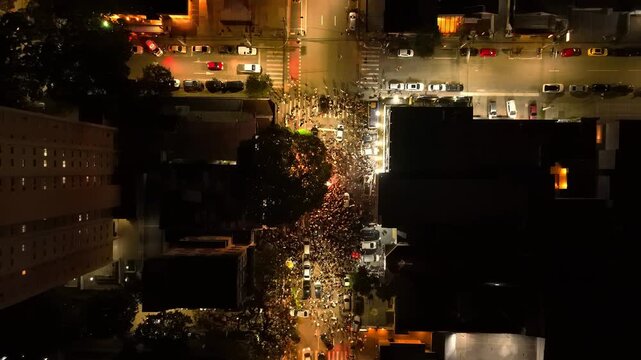 aerial view of a partying crowd in a busy street in Sao Jose dos Campos, countryside of Sao Paulo state in Brazil