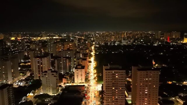 night aerial view of downtown Sao Jose dos Campos with bright lights over a busy street 