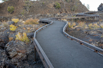Walking path through a Lava field showing different types of lava flows in Idaho