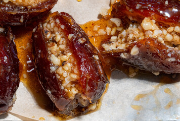 Dates stuffed with nuts and pepper and cooked in honey ancient food