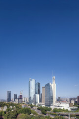 Obraz premium Urban Skyline with Modern Skyscrapers and Clear Blue Sky