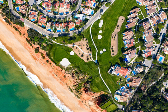 Luxury Living in the Golden Triangle: Cinematic 4K Aerial of Vale do Lobo Royal Golf Course and the Iconic Crimson Cliffs of Praia do Trafal, Algarve, Portugal