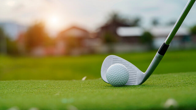 Golf clubs and golf balls on a green lawn in a beautiful golf course with morning sunshine. - Powered by Adobe