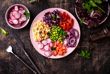 Balanced healthy bowl with vegetables and salmon