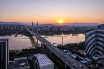 Sunset Over Urban Bridge with Cityscape