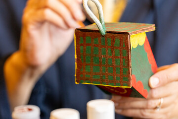 Shallow DOF image of woman painting a small birdhouse arts and crafts concept