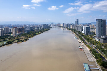Urban Skyline Along a River with Skyscrapers