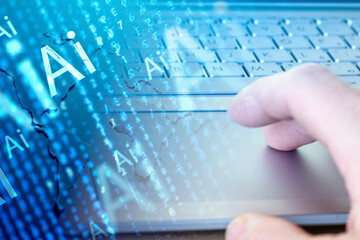 Close-up of gray keyboard and hand over touchpad.