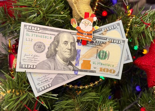 christmas One Hundred dollar bills. Money on Christmas tree.Christmas luck and wealth. Christmas gift concept.