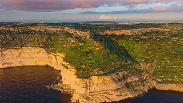 Drone view of countryside, rocks, hills. Dingli cliffs, sunset spot. Mediterranean sea, Malta island