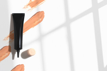 foundation primer cream lotion cosmetic for makeup, product mockup packaging tube bottle in flat lay close-up view