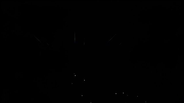A stunning video of fireworks exploding in a dark sky with a rainbow prism filter. This creative display features colorful light refraction and vibrant spectral patterns for festive celebrations.