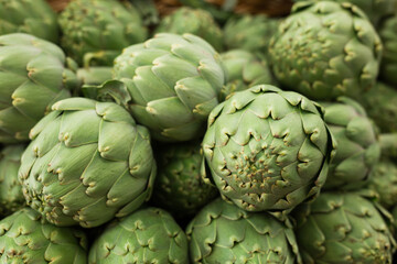 Fresh artichokes on market counter