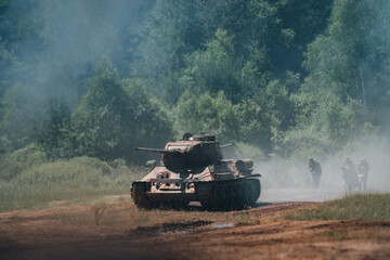Soviet T-34/85 tank drives through forest battlefield, iconic machine of World War II, dynamic military equipment. Event of the Bahna 2025 ground forces parade, June 21 in the Czech Republic.