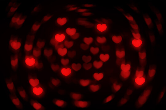 Abstract beautiful romantic photo of brightness red colored of swirling heart shaped soft bokeh on black background, image for Valentine&rsquo;s day or Love or Romance concept.