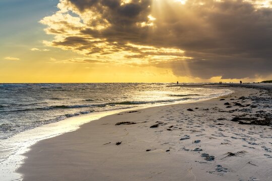 view of the pristine idyllic Dueodde Beach o nthe Danish island of Bornholm in warm evening light