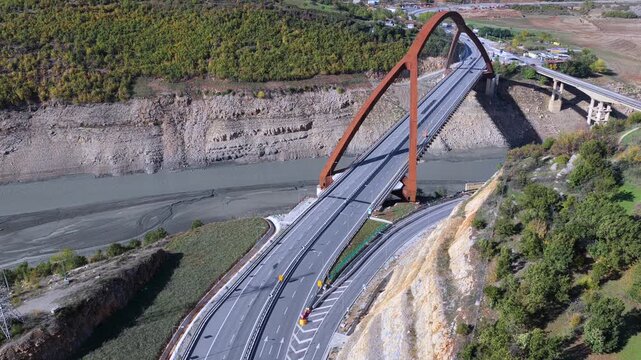 Aerial video of Kuk&euml;s showing the A1 bridges, lake shoreline, and surrounding hills in warm autumn tones.