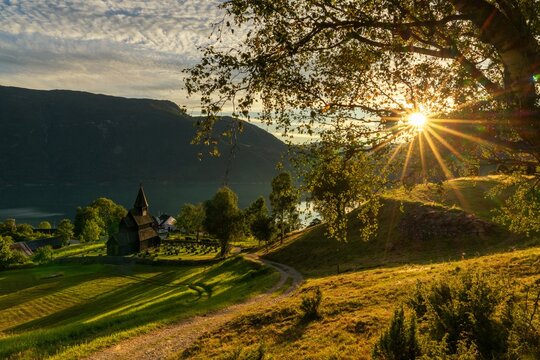 Ornes village and the historic Urnes Stave Church on the Lustrafjorden in Norway at sunset