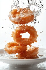 floating calamari rings with tartar sauce splash, isolated on white background