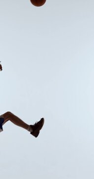 Basketball player lifting ball overhead preparing controlled jump shot. Concept of technique training, shooting mechanics, athlete development, and skill-focused sports education.