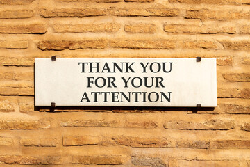 Thank you for your attention symbol. Concept words Thank you for your attention on white marble sign plate. Beautiful brick wall background. Business thank you for your attention concept. Copy space.