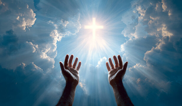 Worship prayer faith hope sky hands lifted toward glowing cross and radiant light
