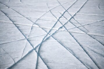 Skating marks on rough textured ice surface in natural light