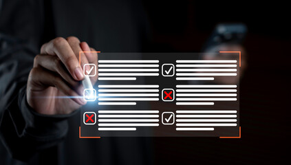 Business hand using stylus pointing at digital checklist with checkmarks and X marks, symbolizing audit, data validation, error review, and online performance assessment.