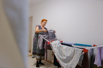 Washed clothes are dried on a dryer. High quality photo