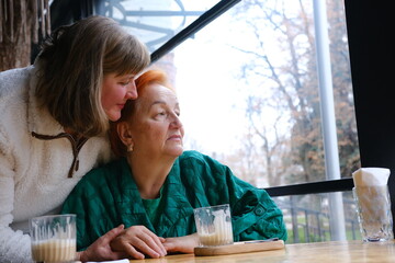 Two elderly women enjoying a peaceful moment by the lake, embracing each other and sharing a heartwarming connection at sunset. High quality photo