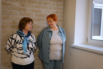 Consultation, home and nurse with senior woman on sofa for diagnosis, checkup or treatment plan. Healthcare, conversation and medical caregiver with elderly female person for discussion.