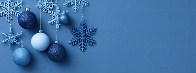 a festive scene with blue christmas balls, each adorned with white snowflakes, hanging against a backdrop of a plain, dark wall