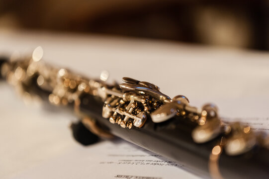 Close-up of a flute on a sheet of music