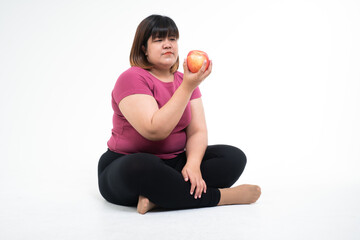 Contemplative Glance: A woman sits cross-legged, gazing thoughtfully at a perfect apple in hand, possibly pondering its taste or the balance it represents in her life.