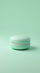 Cool mint green background with a 3D small macaron in the middle, pastel-colored and delicate 