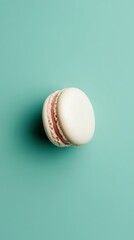 Cool mint green background with a 3D small macaron in the middle, pastel-colored and delicate 