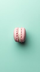 Cool mint green background with a 3D small macaron in the middle, pastel-colored and delicate 