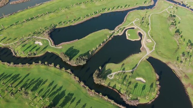 The Ultimate Retirement Dream: Cinematic Aerial Flyover of Salgados Golf Course Nestled Between the Atlantic Ocean and Natural Lagoons in Algarve, Portugal
