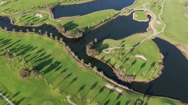The Ultimate Retirement Dream: Cinematic Aerial Flyover of Salgados Golf Course Nestled Between the Atlantic Ocean and Natural Lagoons in Algarve, Portugal