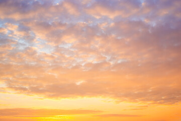 Fototapeta premium Beautiful sky with clumps of clouds at sunset, soft pink-orange colors. Heavenly landscape
