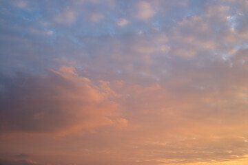 Obraz premium dark evening cloudy sky at sunset, illuminated by lilac and orange light