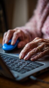 Elderly hands navigating digital technology, bridging generations through computer skills and lifelong learning in the modern age