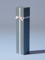 Elegant tall gift box with white ribbon on soft blue background