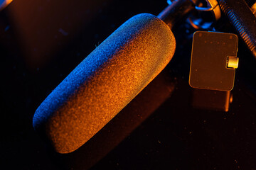 Close up on a professional boom microphone system on black background. © CesareFerrari