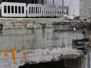 Demolition work on a construction site with concrete pillars, steel beams, etc.