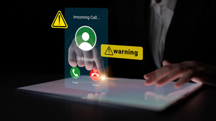 A modern touchscreen device displays an incoming call notification labeled 'Unknown' with warning symbols, showcasing digital interaction in a dark environment. Gantry